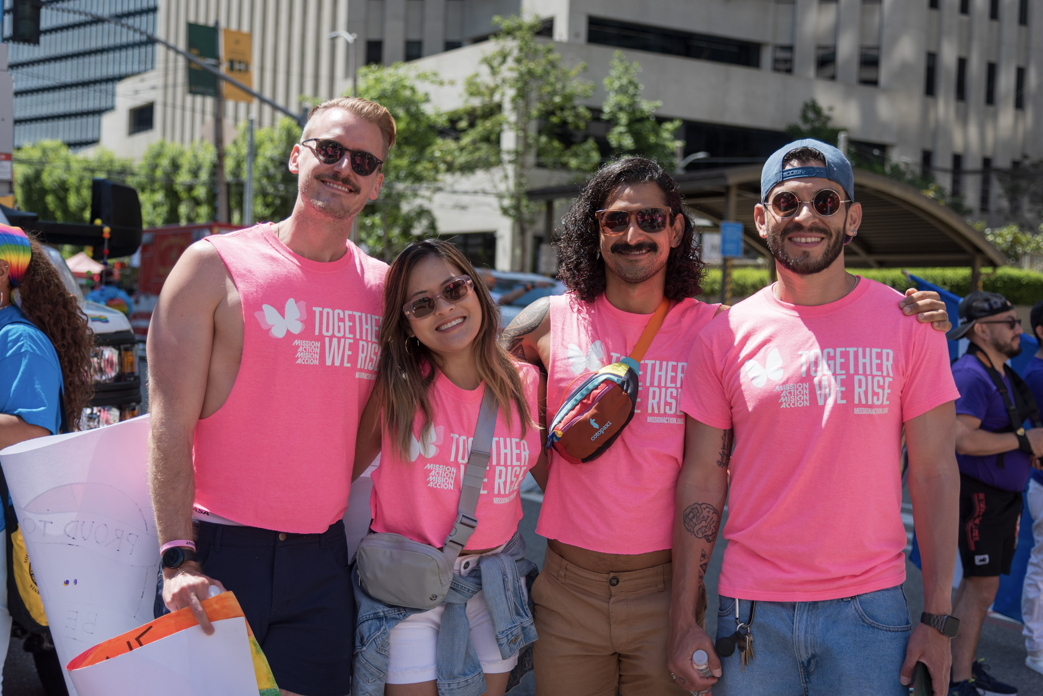 Group of four people in pink shirts at SF Pride